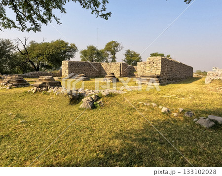 Wide panorama Jandial temple Taxila Pakistan revealing portico foundations and ruinscape Wide panorama Jandial temple Taxila Pakistan revealing portico foundations and ruinscape 133102028