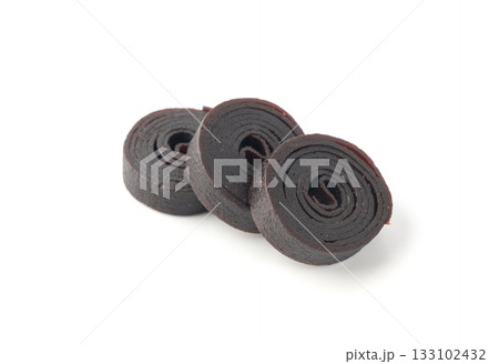 Fruit leather rolls isolated. Plum apple pastila, pastille healthy candy snack 133102432