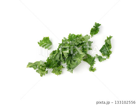 Pieces of kale cabbage leaves isolated. Green leaf of curly cabbage cooked for fresh salad Pieces of kale cabbage leaves isolated. Green leaf of curly cabbage cooked for fresh salad 133102556