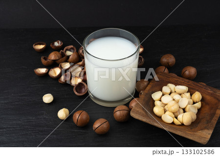 Macadamia nuts. Natural raw peeled macadamia seeds and shells 133102586