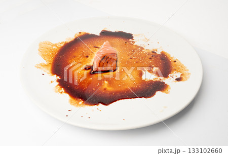 Spilled Soy Sause Leftovers with a Piece of Fish Isolated, Teriyaki Drops on White Plate, Oyster Sauce Spilled Soy Sause Leftovers with a Piece of Fish Isolated, Teriyaki Drops on White Plate, Oyster Sauce 133102660