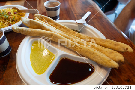Fafda Indian snack food made from chickpea flour with spices. Faafda crispy sticks or fafda 133102721