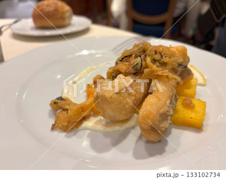 Delicious fish in batter on a restaurant plate 133102734