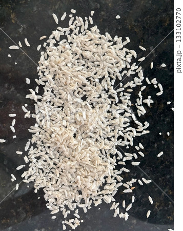 Raw flattened rice close up. Dry rice flakes or poha, Indian breakfast food Raw flattened rice close up. Dry rice flakes or poha, Indian breakfast food 133102770