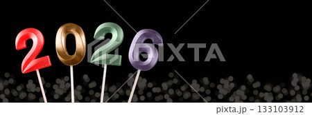 2026 New Year banner. Shiny multicolored numbers glowing with festive lights and garlands, elegant 133103912