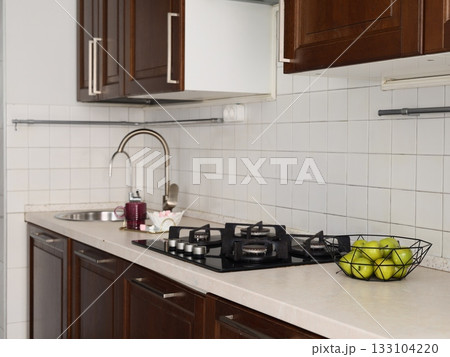 Home chef organizing tools in compact kitchen environment Home chef organizing tools in compact kitchen environment 133104220