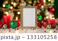 Elegant Golden Frame Displaying Joyeux Noel Greeting Surrounded by Festive Christmas Ornaments and Glowing Candles 133105258
