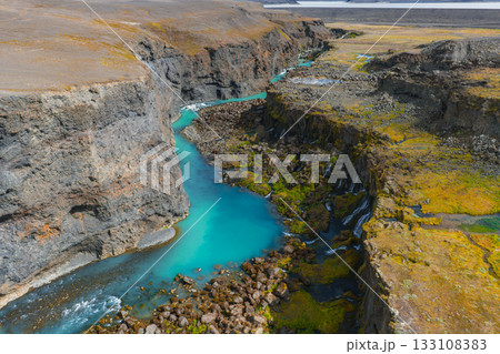 The Sigoldugljufur canyon in Iceland features a turquoise river, steep rocky cliffs, mossy vegetation, small waterfalls, and a barren landscape. The Sigoldugljufur canyon in Iceland features a turquoise river, steep rocky cliffs, mossy vegetation, small waterfalls, and a barren landscape. 133108383