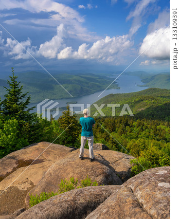Hiker on Black Mountain Overlooking Lake George, New York State, USA Hiker on Black Mountain Overlooking Lake George, New York State, USA 133109391