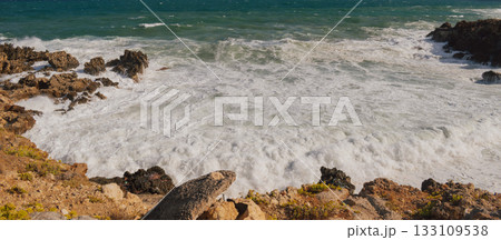 Mediterranean seascape during windy but sunny weather with waves breaking on the shore. 133109538