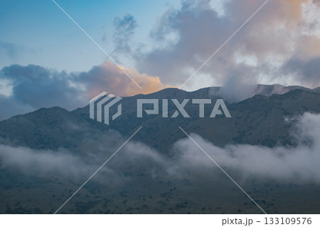 Scenic view of a mediterranean mountain range covered by mist and soft light 133109576