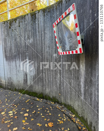 Road Safety Mirror on Concrete Wall in Autumn 133110766