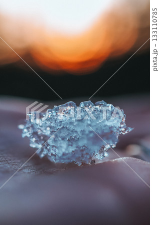 Macro photo of ice crystal glowing in warm sunset light, capturing detailed structure and contrast between cold and warmth Macro photo of ice crystal glowing in warm sunset light, capturing detailed structure and contrast between cold and warmth 133110785