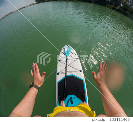 Paddleboarding on a Serene Lake Paddleboarding on a Serene Lake 133111469