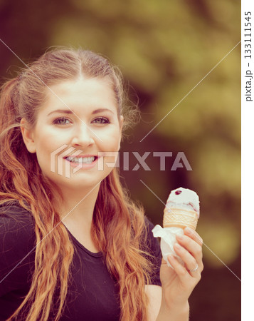 Young woman eating ice cream Young woman eating ice cream 133111545