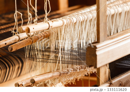 Oldfashioned thread on old spindle, spinning wheel 133111620