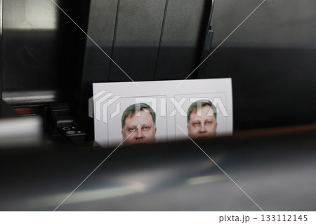 Printing documents on a printer. Photo studio service - creating photos for passports, passes, and ID cards 133112145