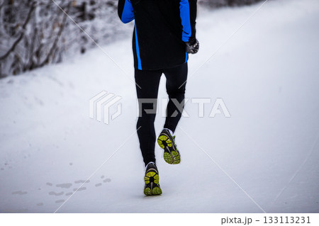 Rear view runner man legs running winter park Rear view runner man legs running winter park 133113231