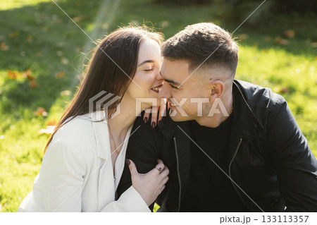 Romantic Couple Laughing Together in a Sunny Park 133113357