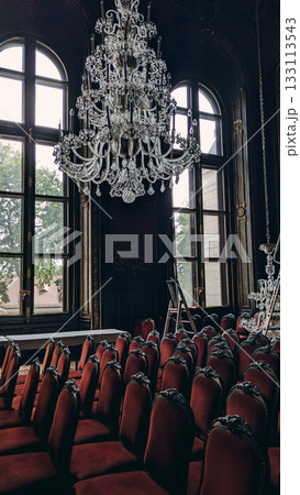 Historic Hall with Chandelier and Velvet Chairs 133113543