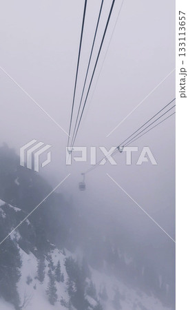 Cable Car in Foggy Winter Mountains 133113657