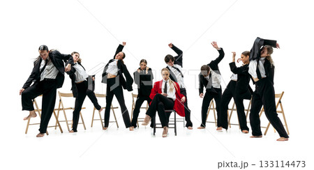 Business team performing expressive synchronized poses around confident leader in red coat 133114473