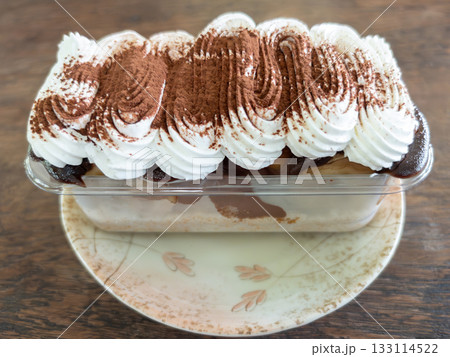 Banoffee Cake with Whipped Cream and Cocoa Powder. Banoffee Cake with Whipped Cream and Cocoa Powder. 133114522