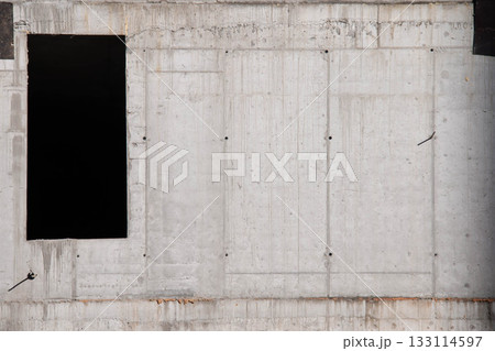 Concrete Wall Frame of Building under Construction with Formwork Prints Smudges on Surface. Architectural origin of Structure. Monolithic box with window holes and floor slabs at Construction Site. Concrete Wall Frame of Building under Construction with Formwork Prints Smudges on Surface. Architectural origin of Structure. Monolithic box with window holes and floor slabs at Construction Site. 133114597