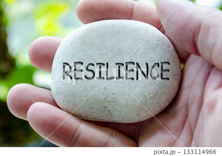 Resilience text engraved on white stone. Life harmony concept Resilience text engraved on white stone. Life harmony concept 133114966