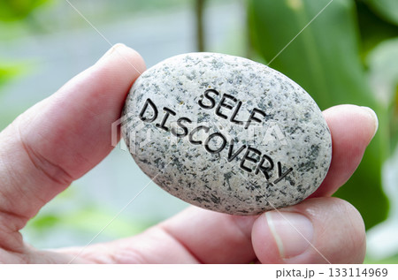 Self Discovery text engraved on dark stone. Life harmony concept Self Discovery text engraved on dark stone. Life harmony concept 133114969