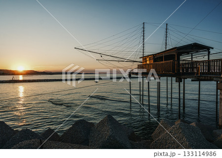Trabocco structure at sunset in Pescara seascape, Italy. 133114986