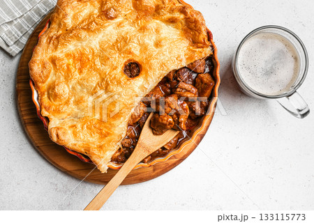 Beef steak pie with dark beer gravy and crispy puff pastry 133115773