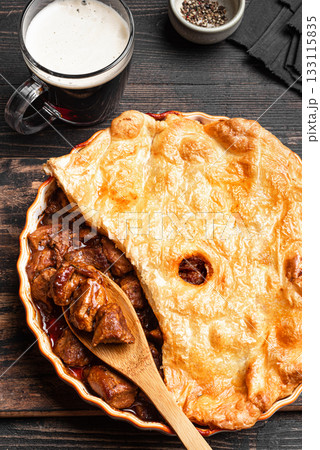Beef steak pie with dark beer and crispy puff pastry 133115835