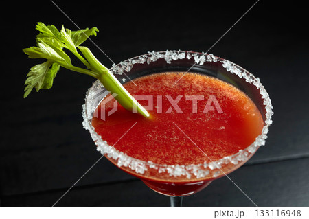 Bloody Mary cocktail with celery on a black background. Bloody Mary cocktail with celery on a black background. 133116948
