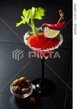 Bloody Mary cocktail with celery, lime, red pepper, and green olives. Bloody Mary cocktail with celery, lime, red pepper, and green olives. 133116949