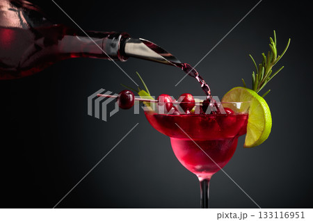 Cranberry cocktail with berries, lime, and rosemary. 133116951