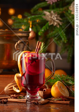 Christmas mulled wine with spices, citrus, and vintage kitchen utensils. 133116954