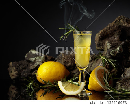 Traditional homemade lemon liqueur limoncello on the black background. Traditional homemade lemon liqueur limoncello on the black background. 133116978