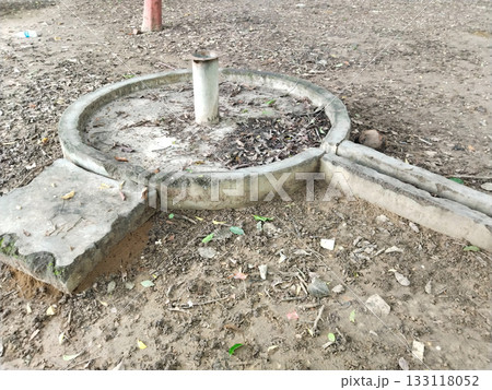 Old concrete water handpump base in park, circular structure with pipe and drainage, Old concrete water handpump base in park, circular structure with pipe and drainage, 133118052