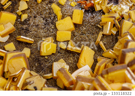 Macro mineral stone yellow Wulfenite on a white background 133118322