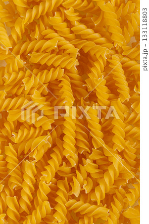 Pasta products in the form of a spiral, texture, on a white background 133118803