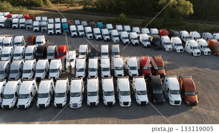 A group of trucks parked in a large lot, rows of vehicles under a clear sky, A group of trucks parked in a large lot, rows of vehicles under a clear sky, 133119005