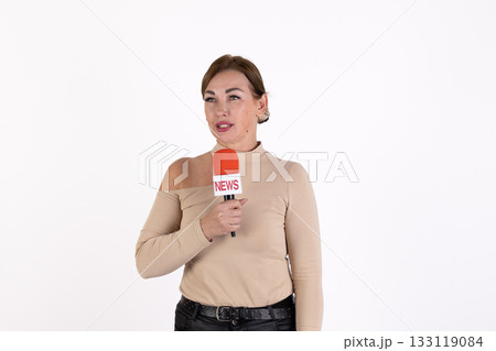The reporter is holding a microphone and speaking 133119084
