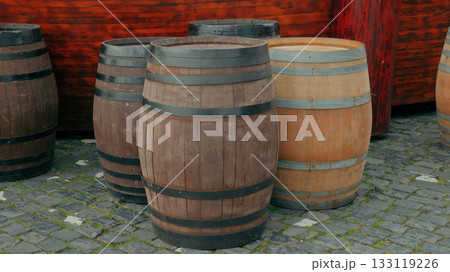 Rustic wooden barrels displayed outdoors in a historic setting Rustic wooden barrels displayed outdoors in a historic setting 133119226