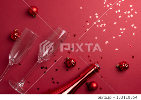 Red Holiday Celebration with Champagne Flutes, Bottle, and Ornaments 133119354