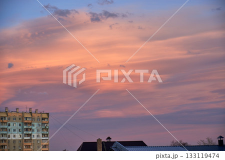 Lenticular round clouds over houses in the city at sunset 133119474