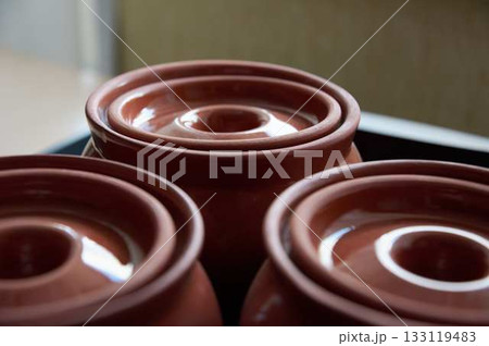 Close-up of upturned clay baking pot lids. Close-up of empty clay pots. Close-up of upturned clay baking pot lids. Close-up of empty clay pots. 133119483
