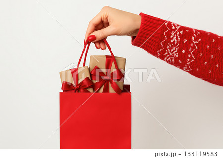 Holiday shopping concept with woman carrying present packages Holiday shopping concept with woman carrying present packages 133119583