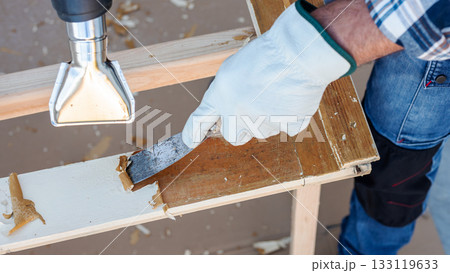 Carpenter at work, restoring an old wooden window. Carpentry. 133119633