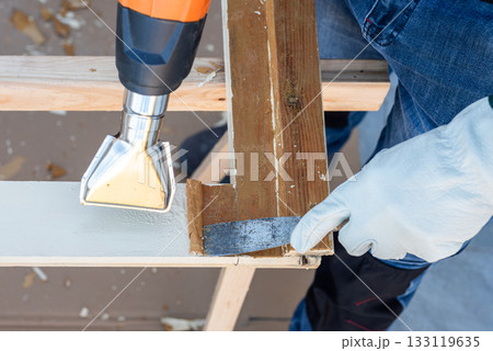 Carpenter at work, restoring an old wooden window. Carpentry. 133119635